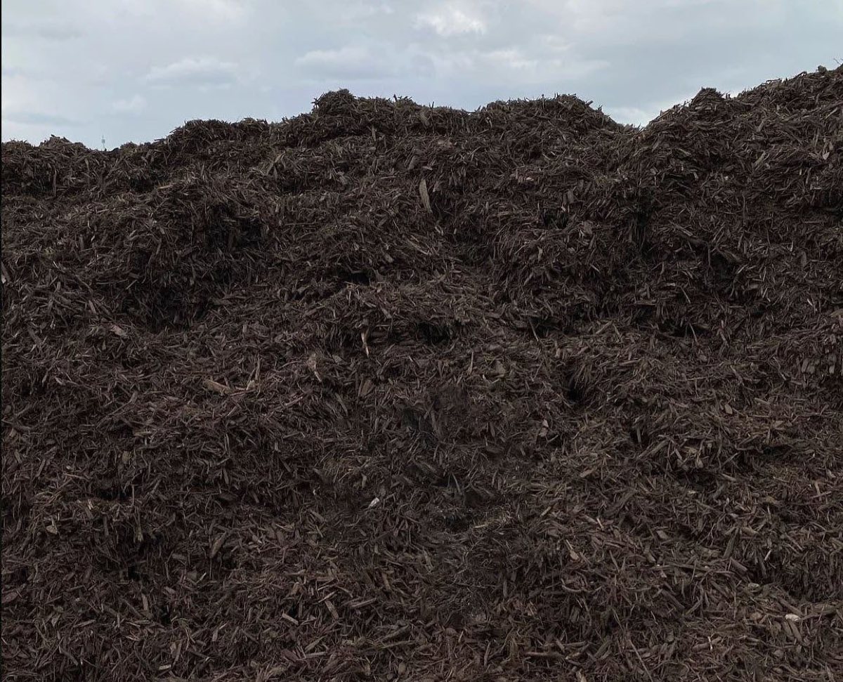 A large pile of chocolate brown dyed mulch