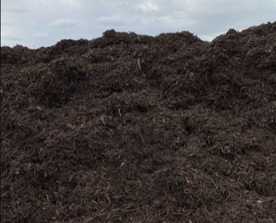 A large pile of chocolate brown dyed mulch