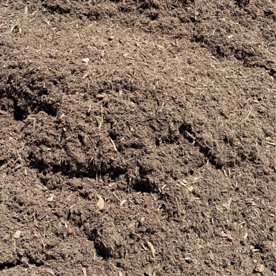 Undyed natural mulch, shredded wood in warm browns that will weather to grey